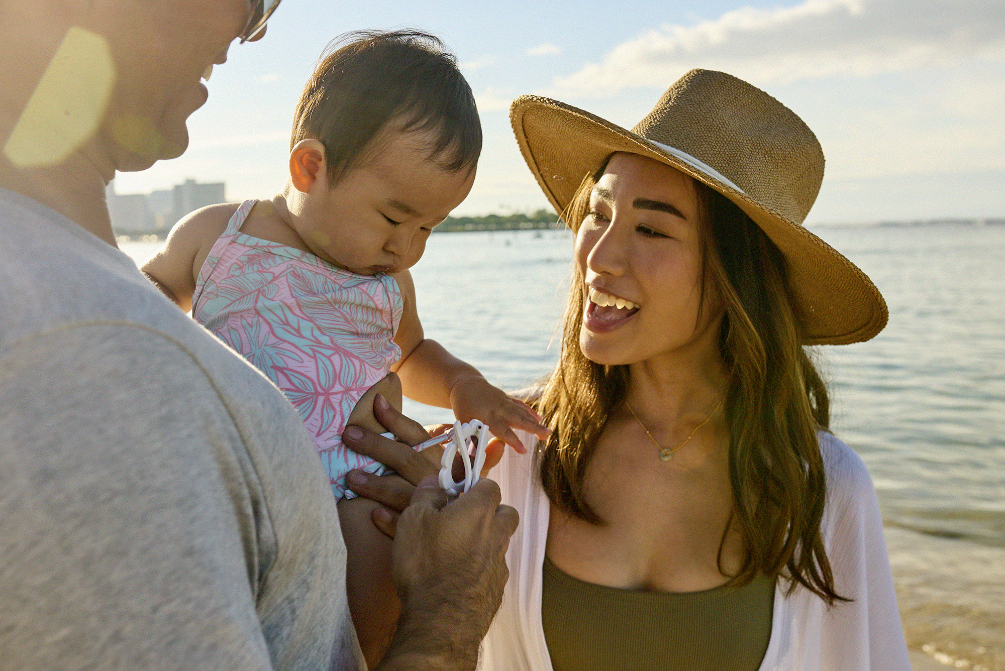 Couple with baby at the shoreline