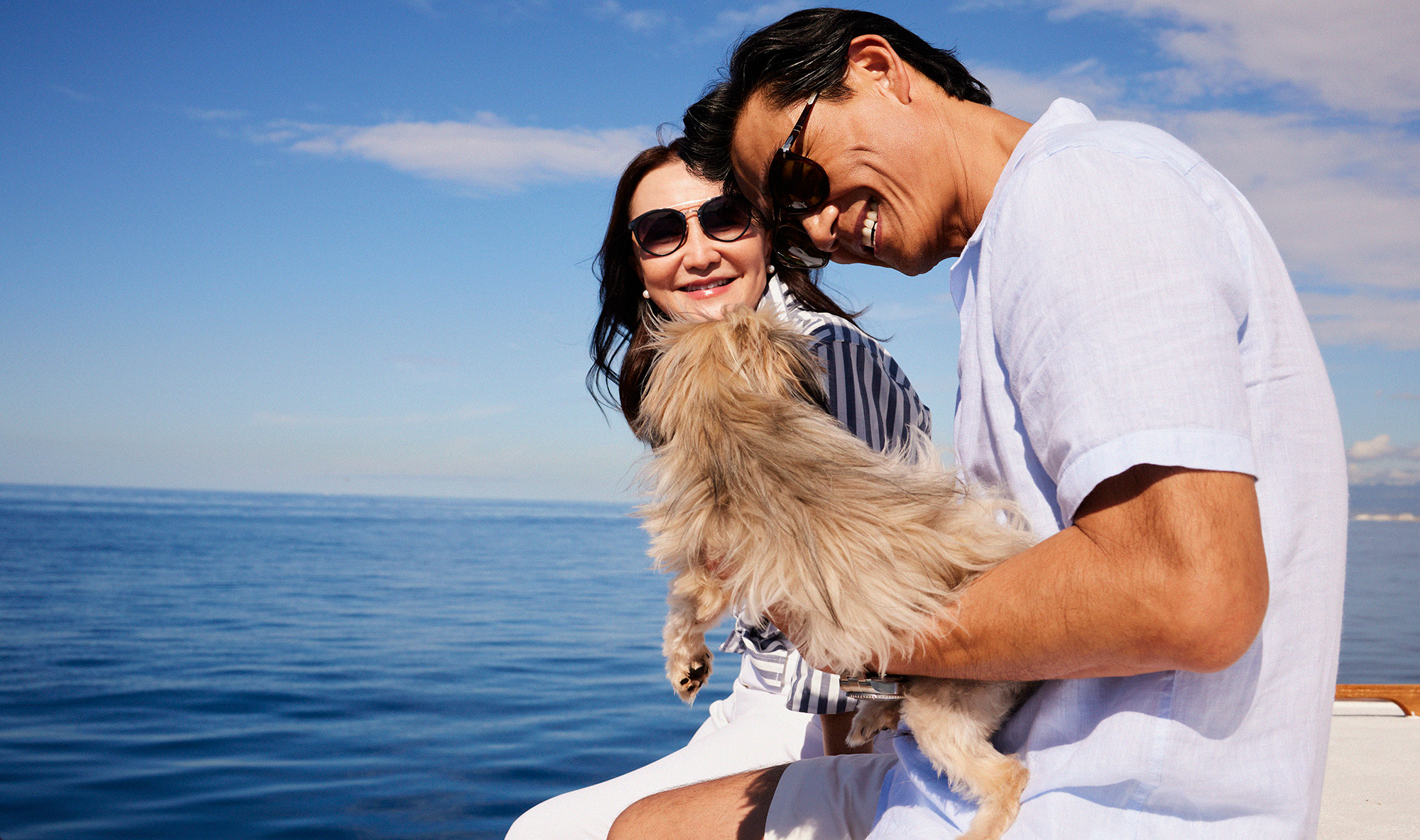 Couple with small dog on boat