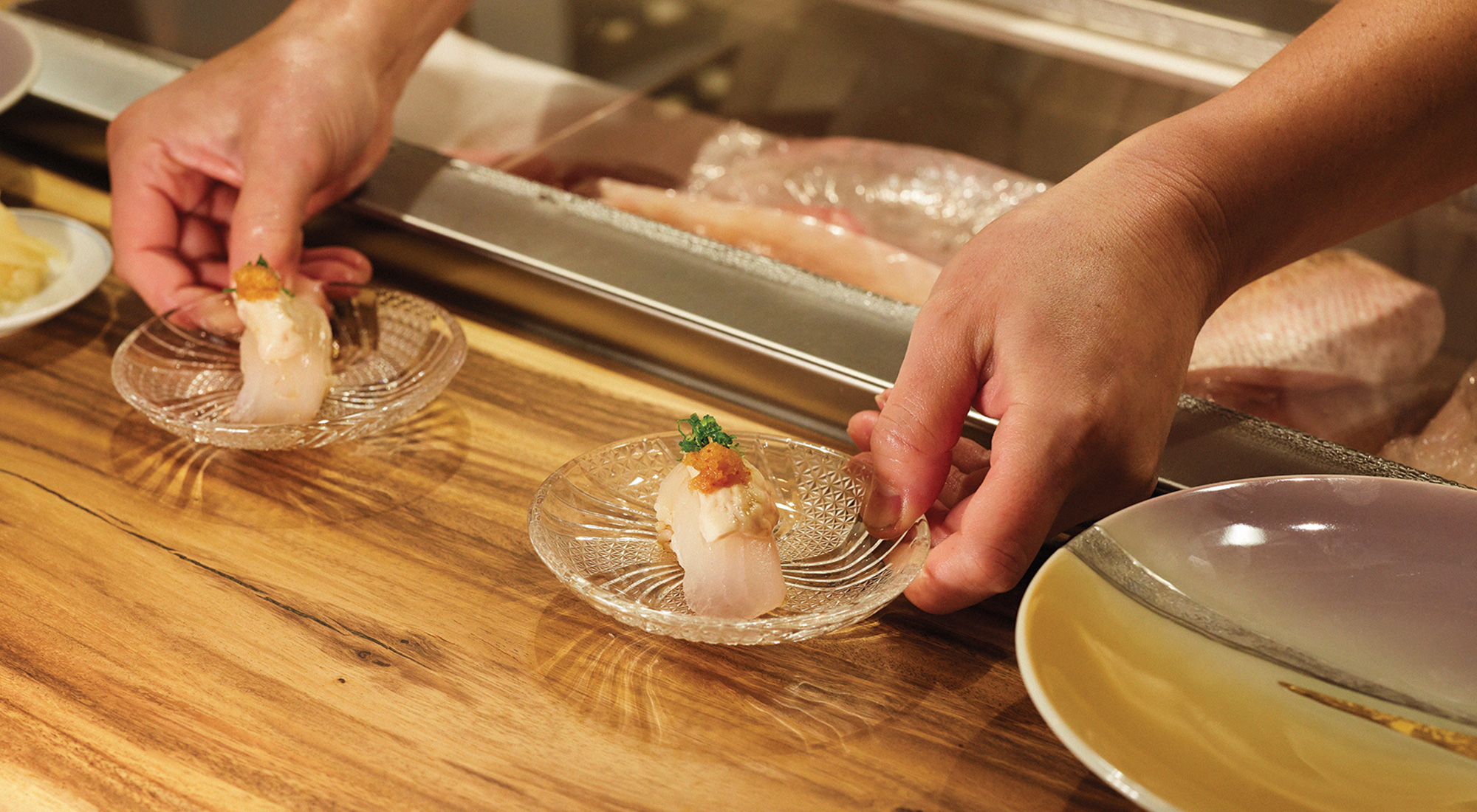 person serving sushi