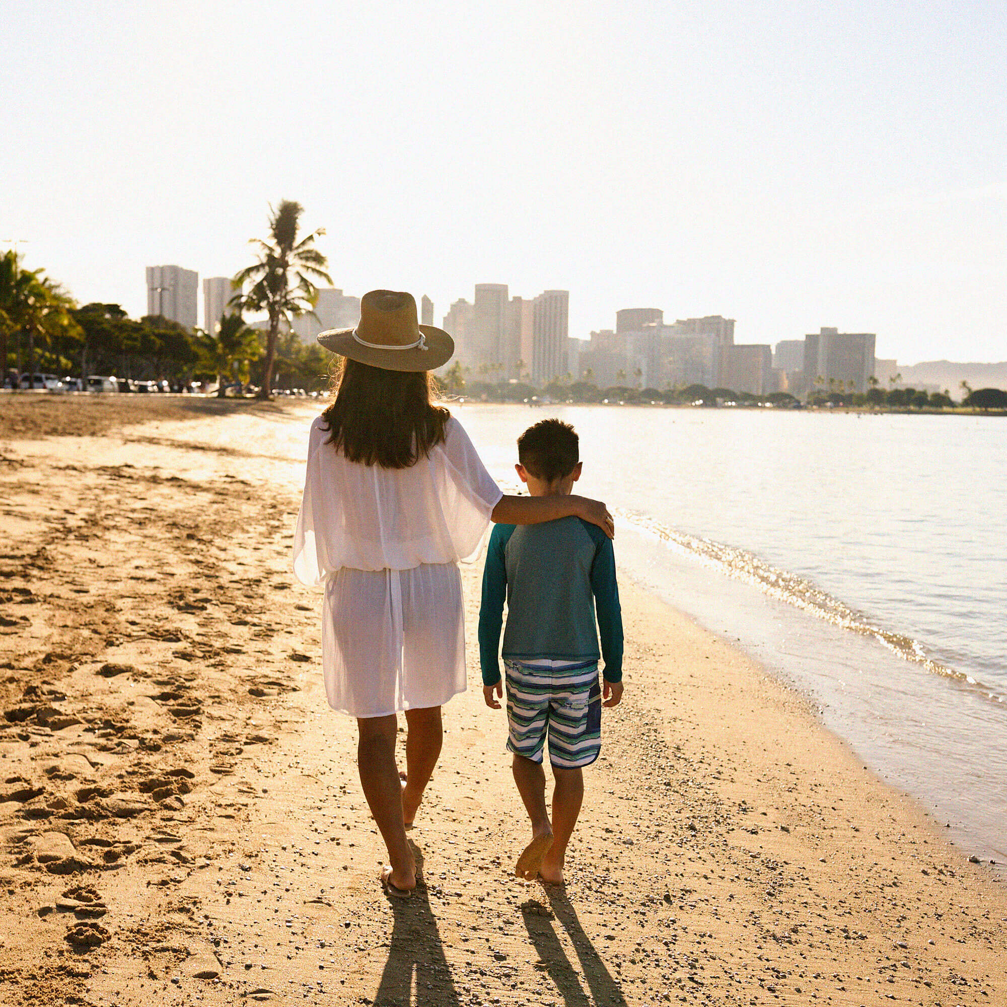 Mother and son walking on beach